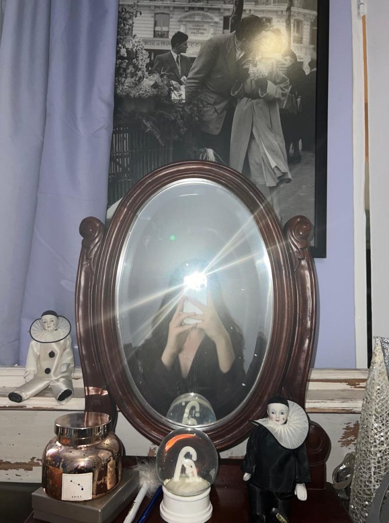 Page taking a photo of a mirror, with her flash on. Therefore, obscuring her reflection.  